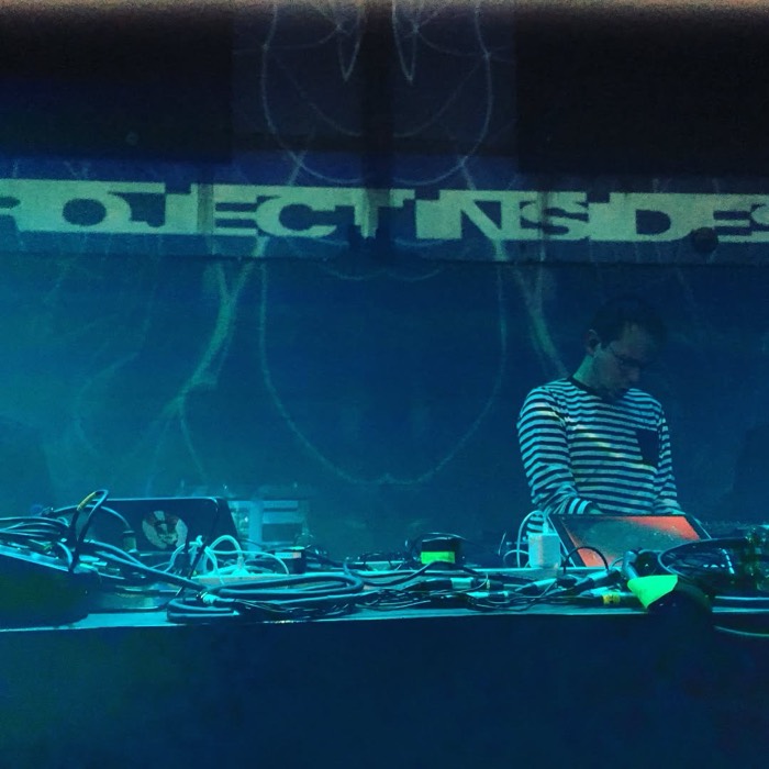 Wider dark blue shot of Rone under PROJECT INSIDE projection