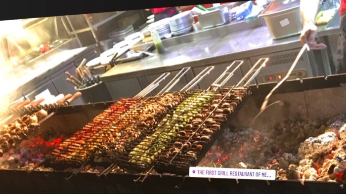 Rotated shot of skewers grilling over coals at famous Lviv grill