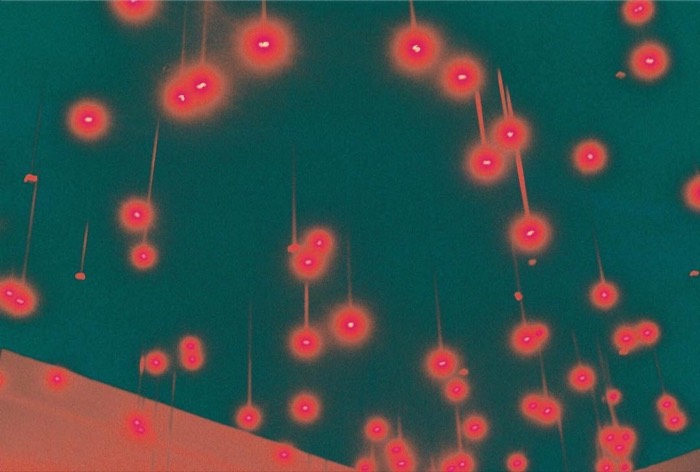 Abstract 35mm: glowing red hanging lights against teal sky, surreal