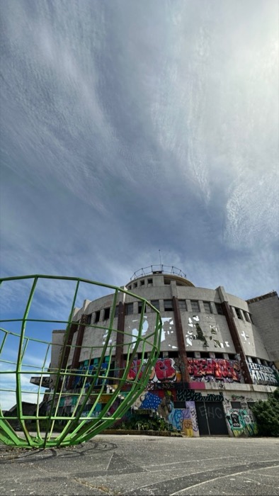 Abandoned graffiti-covered Monsanto panoramic restaurant with green globe sculpture