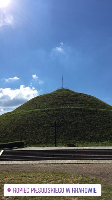 Pilsudski Mound with cross monument under blue sky, Krakow landmark