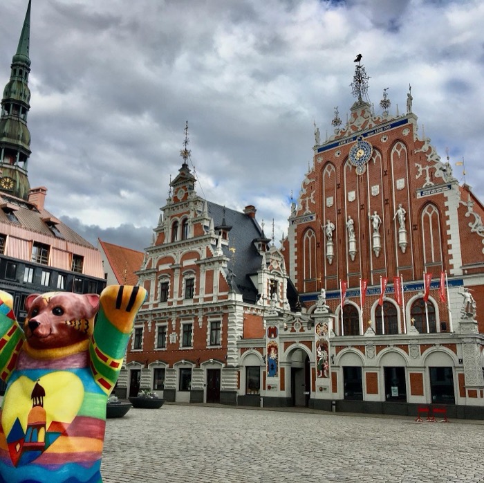House of the Blackheads with colorful Buddy Bear statue, dramatic sky