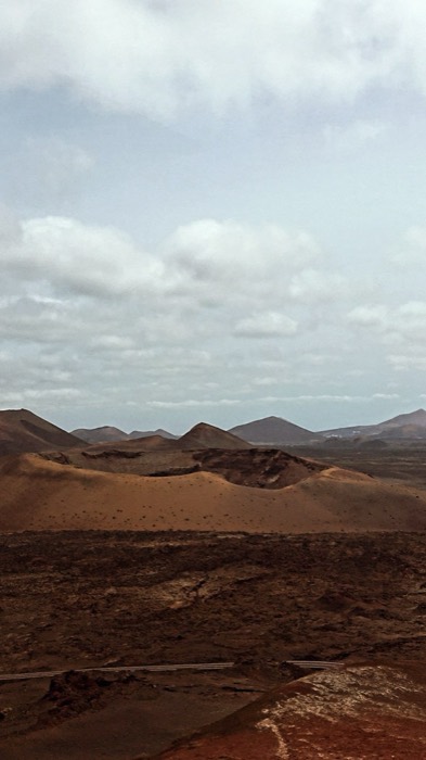 Volcanic crater field under cloudy sky, Mars-like Timanfaya landscape