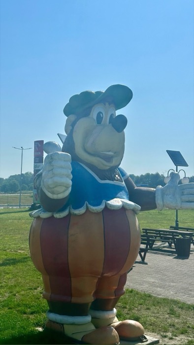Giant cartoon bear mascot statue at Orlen highway rest stop