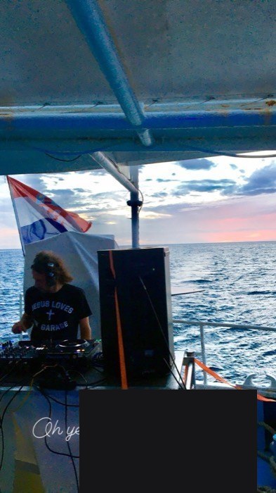 DJ playing on boat deck at sunset, Croatian flag, Letnia Rezydencja party