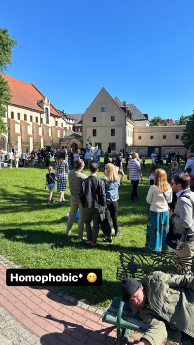 Crowd in church courtyard lawn; man napping on bench, joke caption