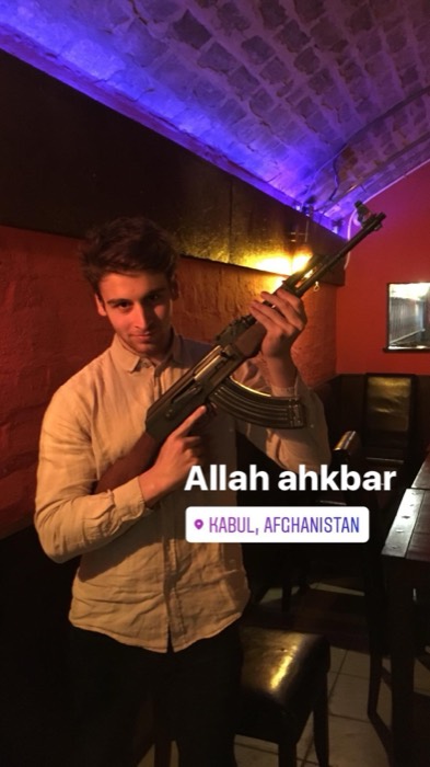 Joshua: posing with replica AK-47 in brick-vaulted bar, joke geotag