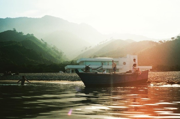 Golden-light 35mm of boat off Ponchon beach beneath Mount Chilbo