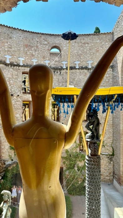 Dali Theatre-Museum courtyard with golden mannequin and boat installation