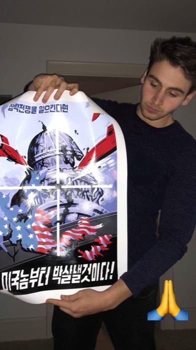 Joshua: holding North Korean anti-American propaganda poster souvenir