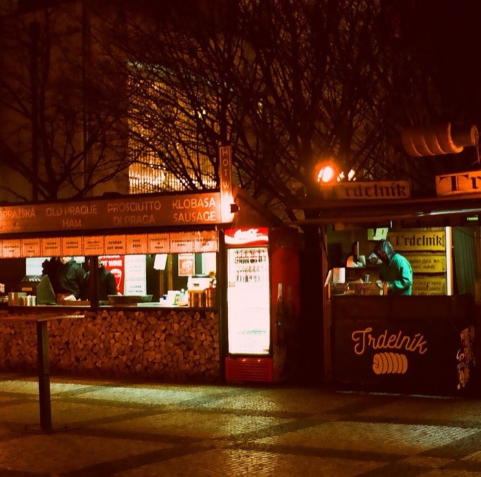 Moody 35mm night shot of Prague Trdelnik and klobasa street stalls
