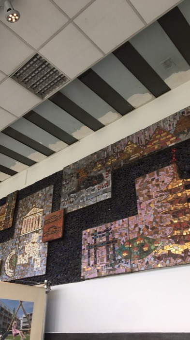 Communist-era ceramic mosaic wall panels inside modernist interior