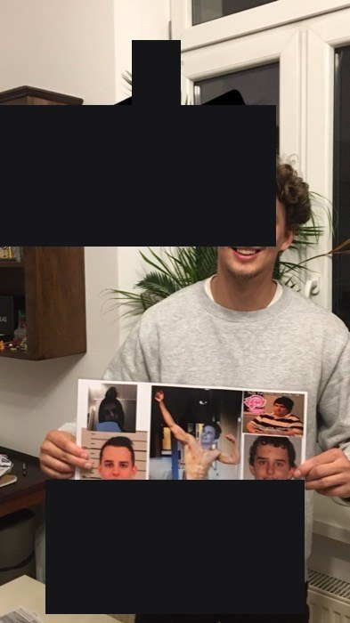Friend Danny grinning with gag photo poster, running birthday joke
