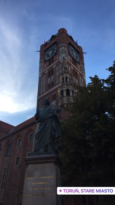 Copernicus monument before gothic Old Town Hall tower, Torun