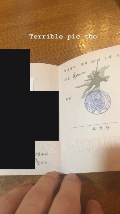 Joshua: his ID photo inside open North Korean tourist card with stamps