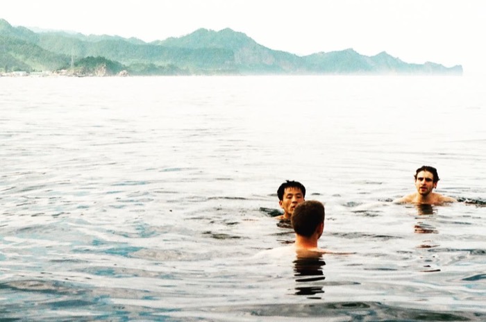 Joshua: swimming in Chilbo Sea with Korean guide and friend