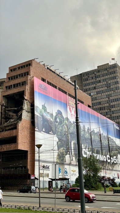 NATO-bombed Yugoslav Ministry of Defence ruins draped with Serbian army banner
