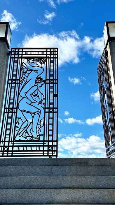 Vigeland Park wrought-iron figure gates against blue sky