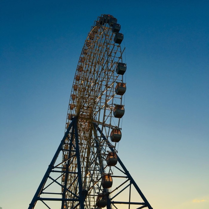 Ferris wheel silhouetted against dusk sky, three-wheels Georgia post