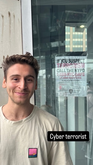 Joshua: grinning beside NYPD terrorism warning poster, security-researcher joke