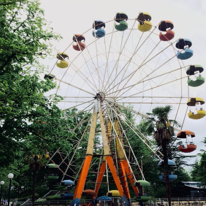 Colourful vintage ferris wheel among trees, Kutaisi park