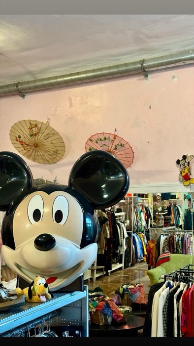 Giant Mickey Mouse head display inside vintage clothing store