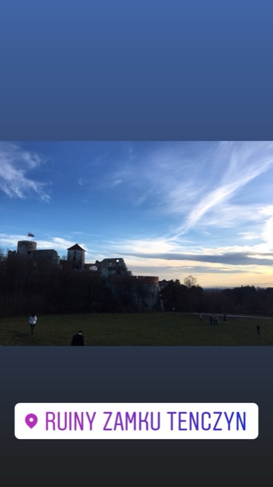 Tenczyn castle ruins silhouetted against dramatic afternoon sky