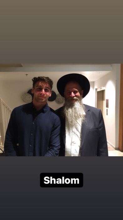Joshua: smiling beside long-bearded Hasidic rabbi in hotel lobby
