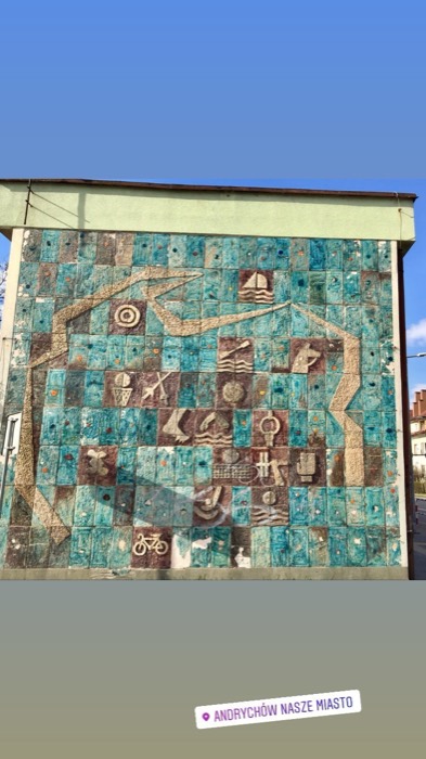 Communist-era turquoise ceramic mosaic mural of sports icons on building wall
