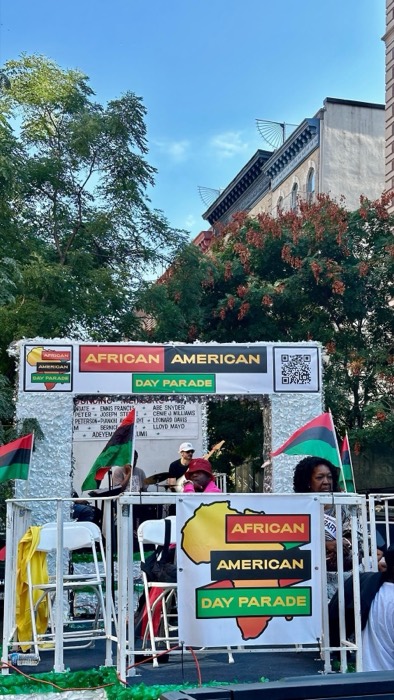 African American Day Parade stage with pan-African flags, Harlem