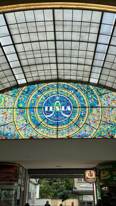 TESLA stained-glass skylight over shopping arcade, retro signage