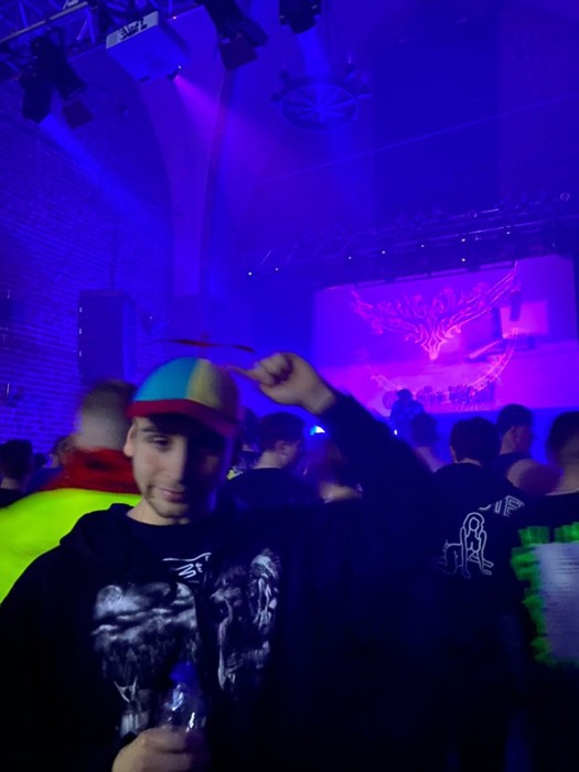 Joshua: propeller hat selfie at dark techno club stage