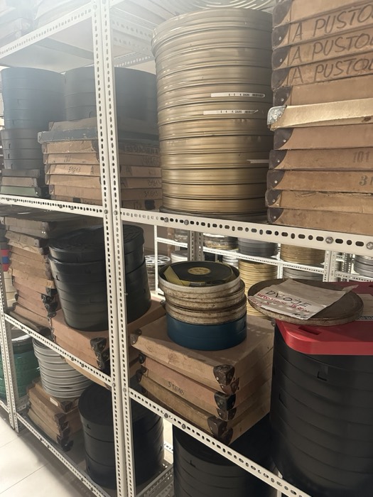 More stacked film reel cans on archive shelving