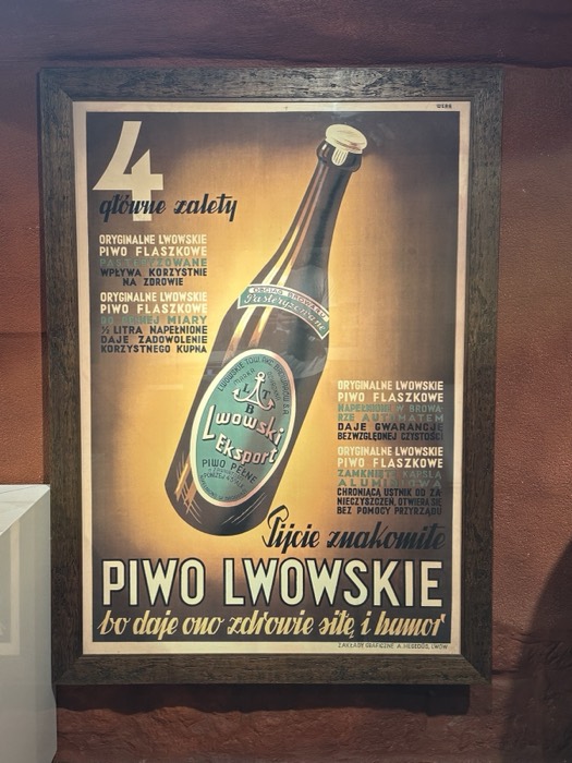 Another framed Piwo Lwowskie beer poster on wooden wall