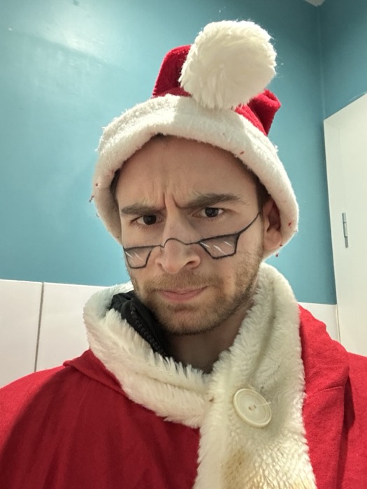 Joshua: deadpan selfie in a Santa hat and costume