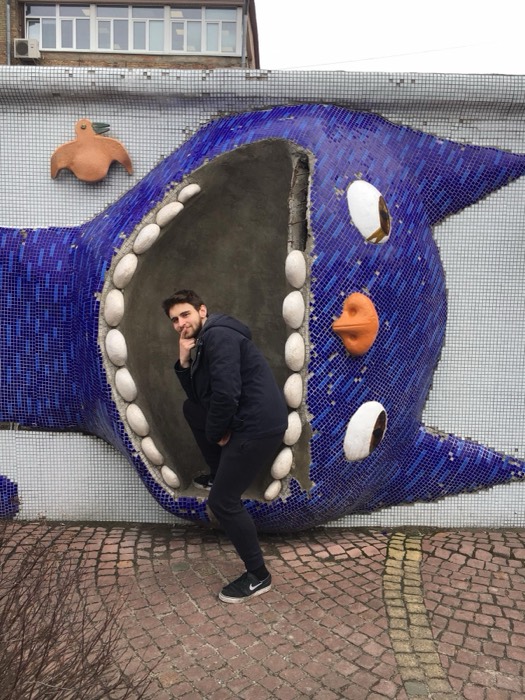 Joshua: posing inside mouth of giant blue mosaic cat-whale wall