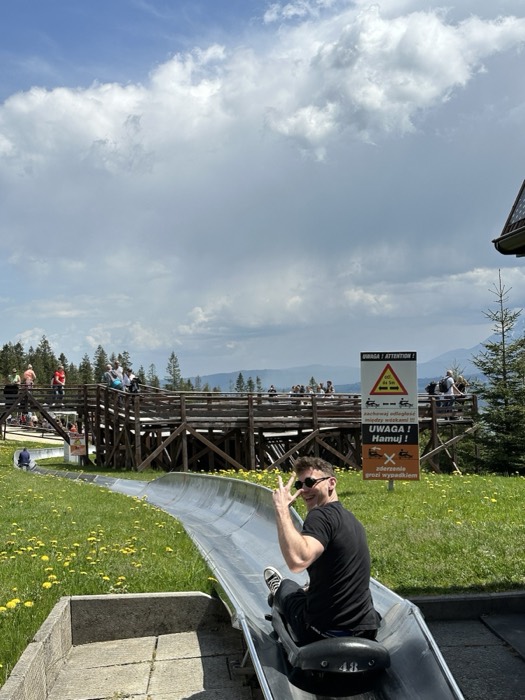 Joshua: peace sign on summer toboggan slide, Tatra mountains behind