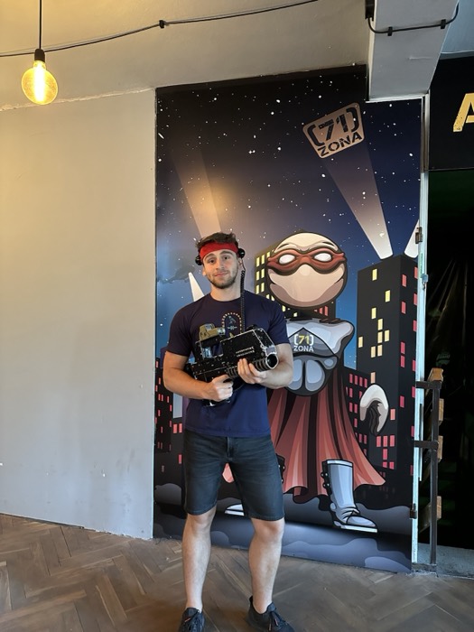 Joshua: posing with a laser-tag gun before a superhero mural