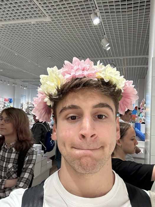 Joshua: selfie wearing pink flower crown in homeware store