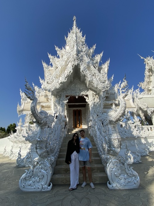 Joshua: with companion posing at White Temple entrance, Chiang Rai