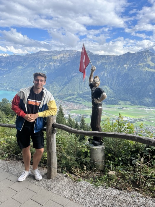 Joshua: posing by Swiss flag statue above Interlaken valley