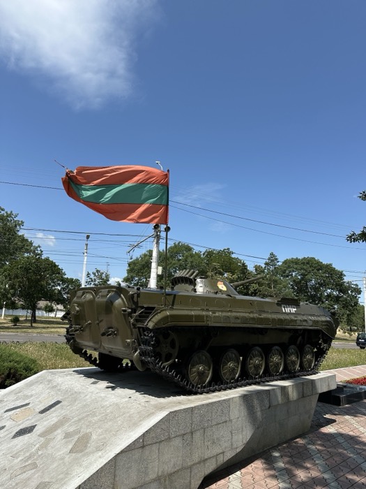 BMP armoured vehicle war memorial with Transnistria flag, blue sky