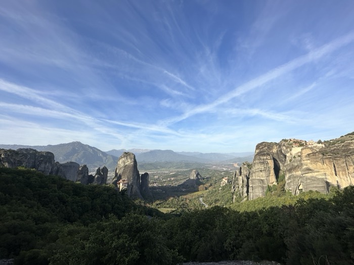 Meteora cliffs and clifftop monasteries under dramatic blue sky