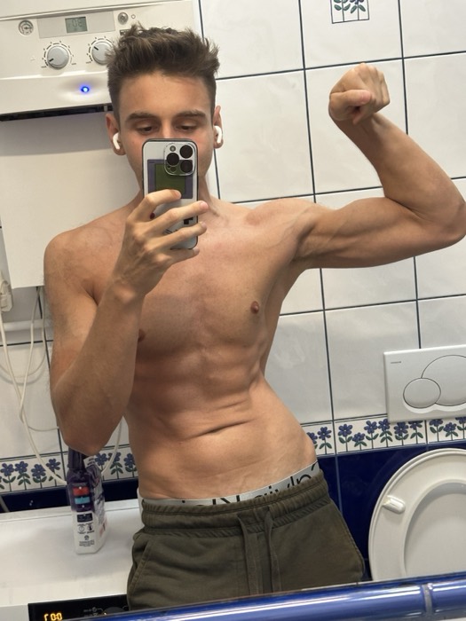 Joshua: shirtless flexing mirror selfie in bathroom