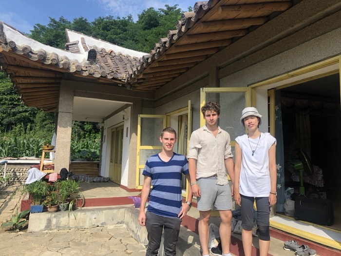 Joshua: friends posing at rural Korean tiled-roof house