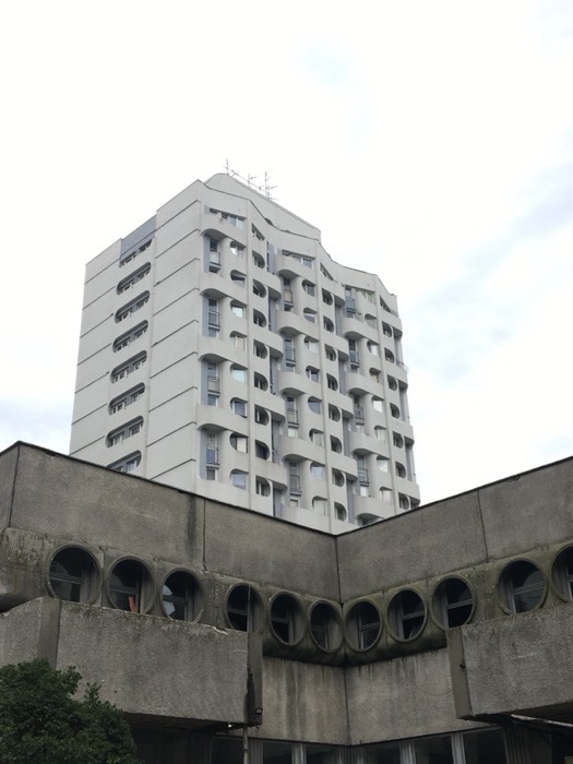 Brutalist tower with porthole windows below
