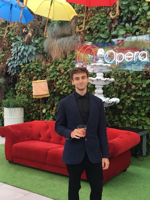 Joshua: navy suit, cocktail at Opera event, red sofa and umbrellas