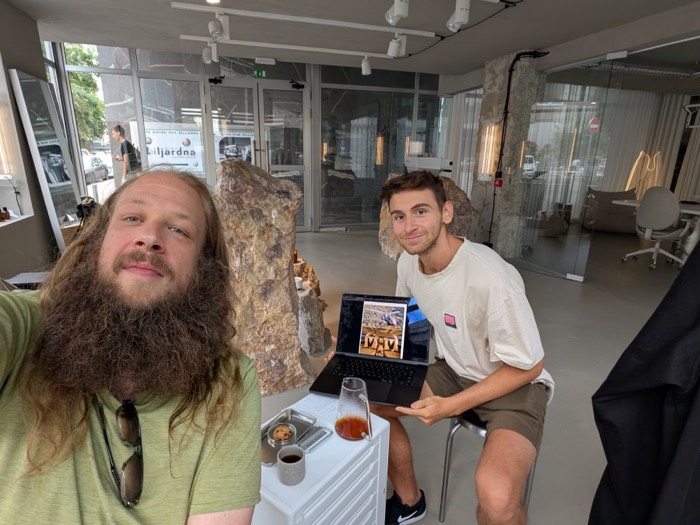 Joshua: with bearded friend in stone showroom, laptop, espresso, coworking