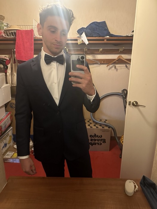 Joshua: tuxedo and bow-tie mirror selfie in cluttered room