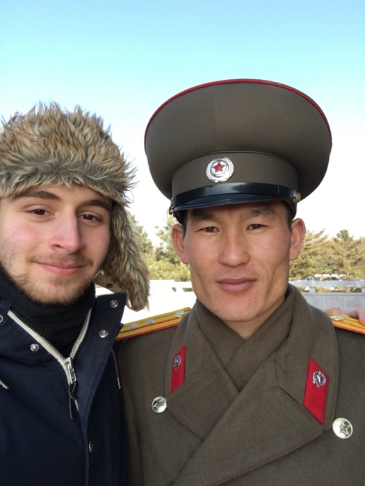 Joshua: selfie in fur hat beside North Korean army officer in uniform